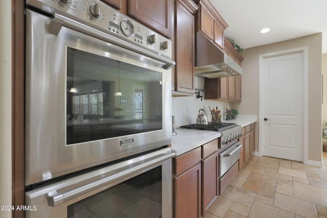 kitchen with double oven and light stone counters