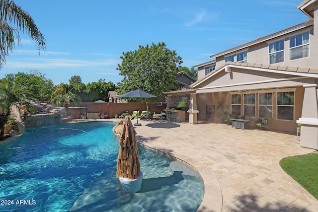 view of swimming pool with a patio and pool water feature