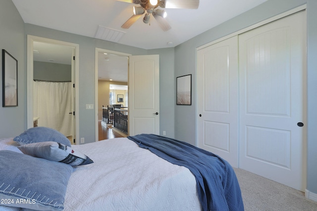 carpeted bedroom featuring ceiling fan and a closet