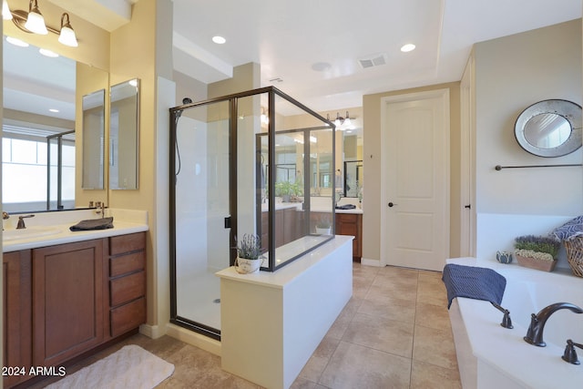 bathroom featuring shower with separate bathtub, tile patterned floors, and vanity