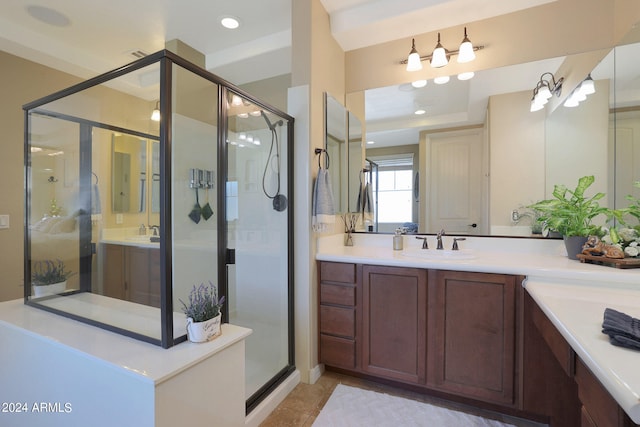 bathroom with tile patterned flooring, a shower with shower door, and vanity