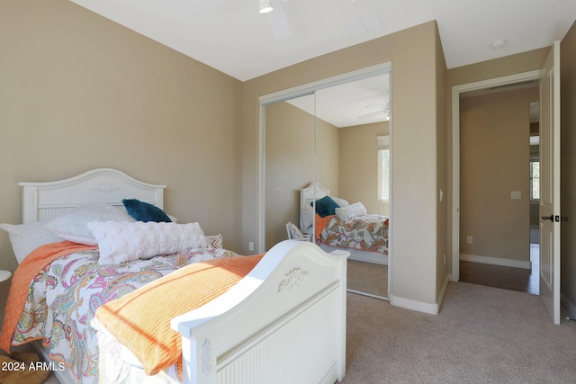 bedroom with ceiling fan, carpet floors, and a closet