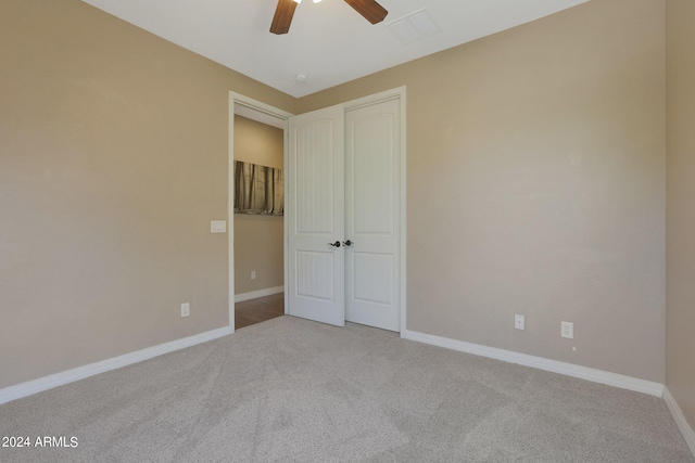 unfurnished bedroom featuring light carpet and ceiling fan