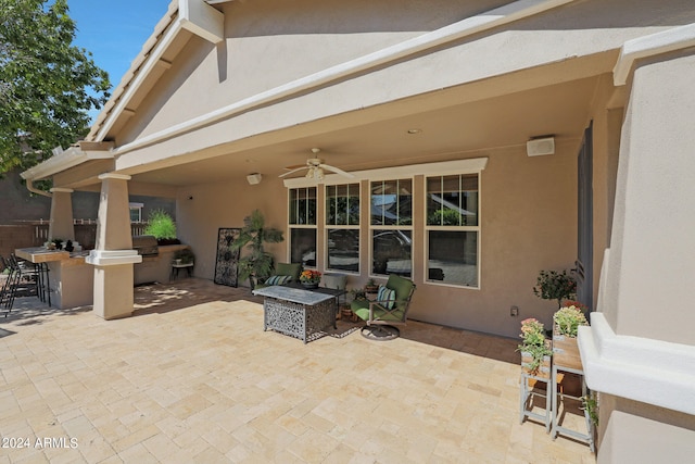 view of patio / terrace with an outdoor kitchen and ceiling fan