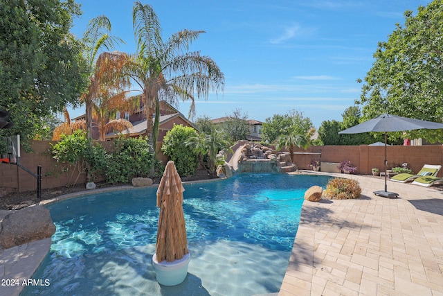 view of swimming pool with a patio area and pool water feature