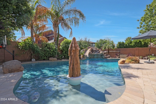 view of pool with a patio area and pool water feature