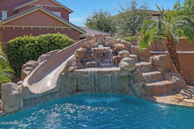 view of pool with pool water feature