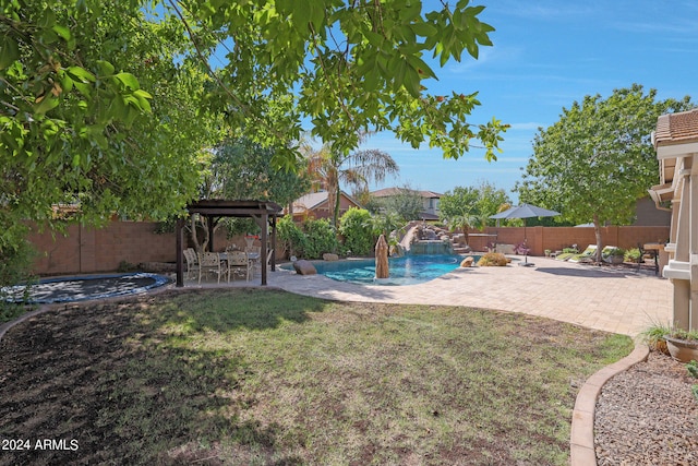 view of yard with a fenced in pool, a patio, and pool water feature