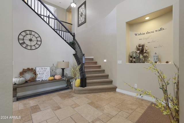 stairs featuring a towering ceiling