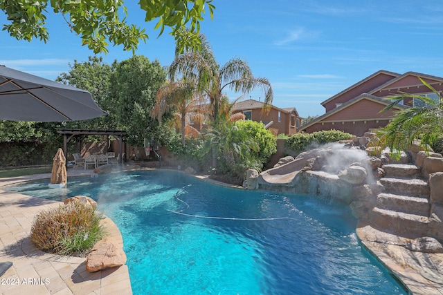 view of swimming pool with a patio and pool water feature