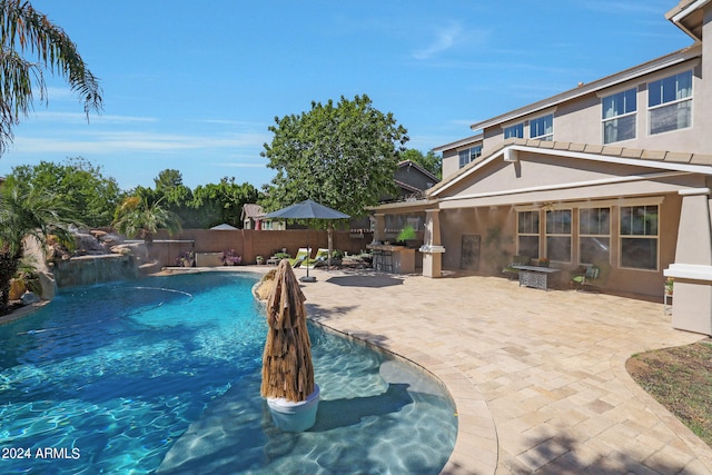 view of swimming pool featuring a patio area and pool water feature