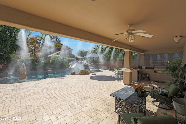 view of patio / terrace featuring ceiling fan, an outdoor kitchen, a grill, and pool water feature