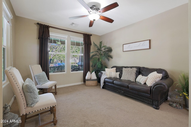 carpeted living room featuring ceiling fan