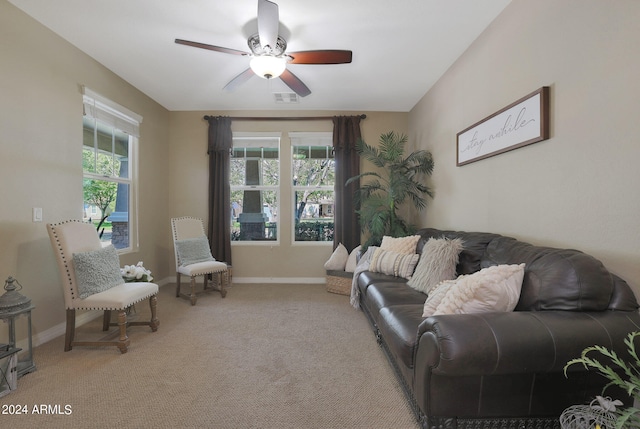 carpeted living room featuring ceiling fan