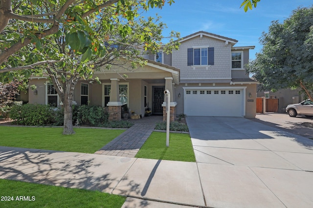 view of front of property with a front yard and a garage