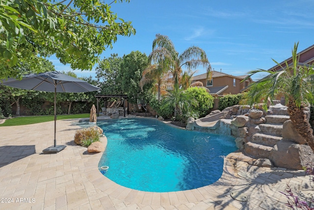 view of swimming pool with a patio and pool water feature