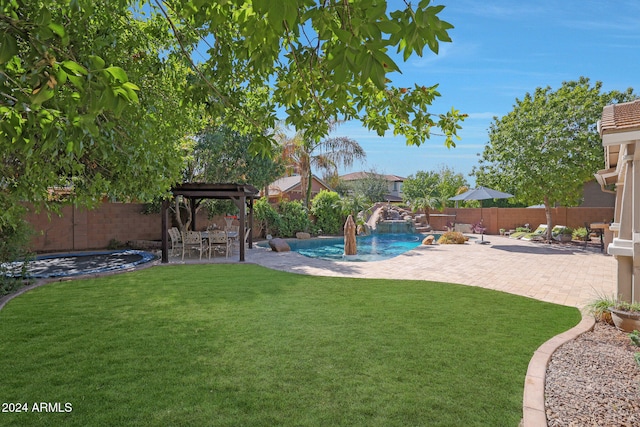 view of yard featuring a fenced in pool, a patio, and pool water feature