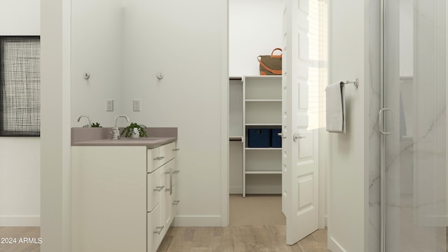 bathroom featuring a shower with shower door, wood-type flooring, and vanity