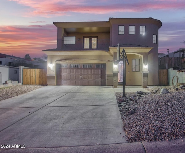 view of front of property with a garage and a balcony