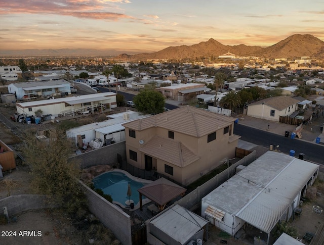 aerial view at dusk featuring a mountain view