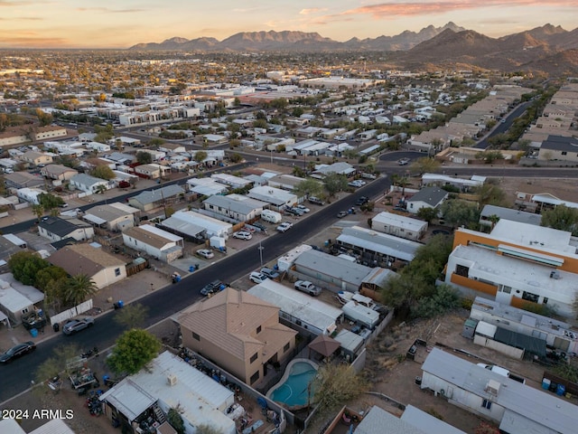 aerial view at dusk featuring a mountain view