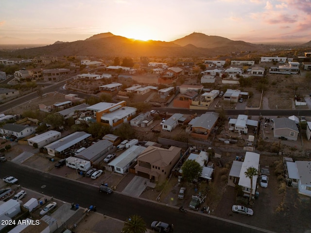 aerial view at dusk featuring a mountain view