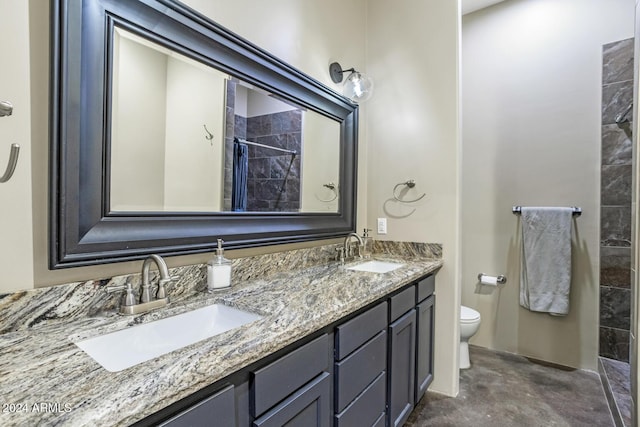 bathroom with walk in shower, vanity, and toilet