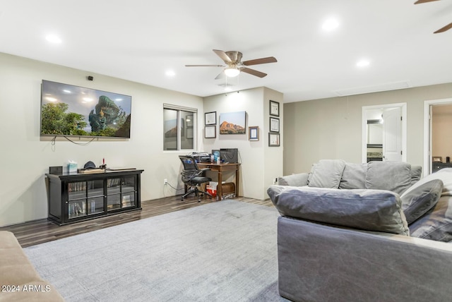 living room featuring ceiling fan and wood-type flooring