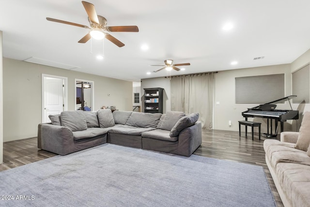 living room featuring ceiling fan and dark wood-type flooring