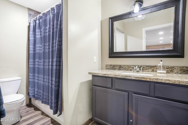 full bathroom featuring toilet, vanity, shower / bath combination with curtain, and wood-type flooring