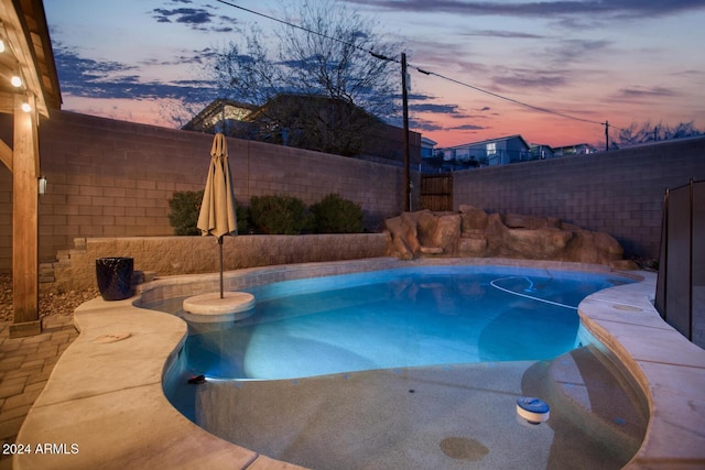 view of pool at dusk