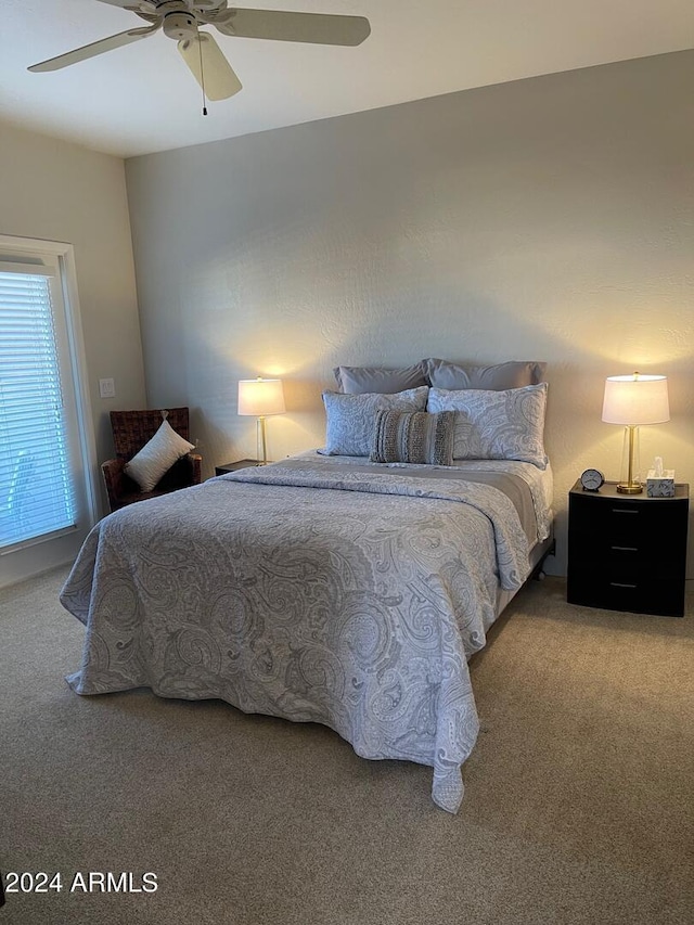 bedroom with ceiling fan and carpet floors