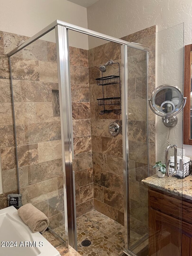 bathroom with vanity and a shower with shower door