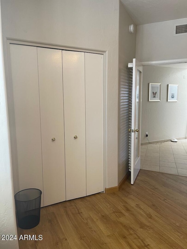 unfurnished bedroom featuring light tile flooring and a closet