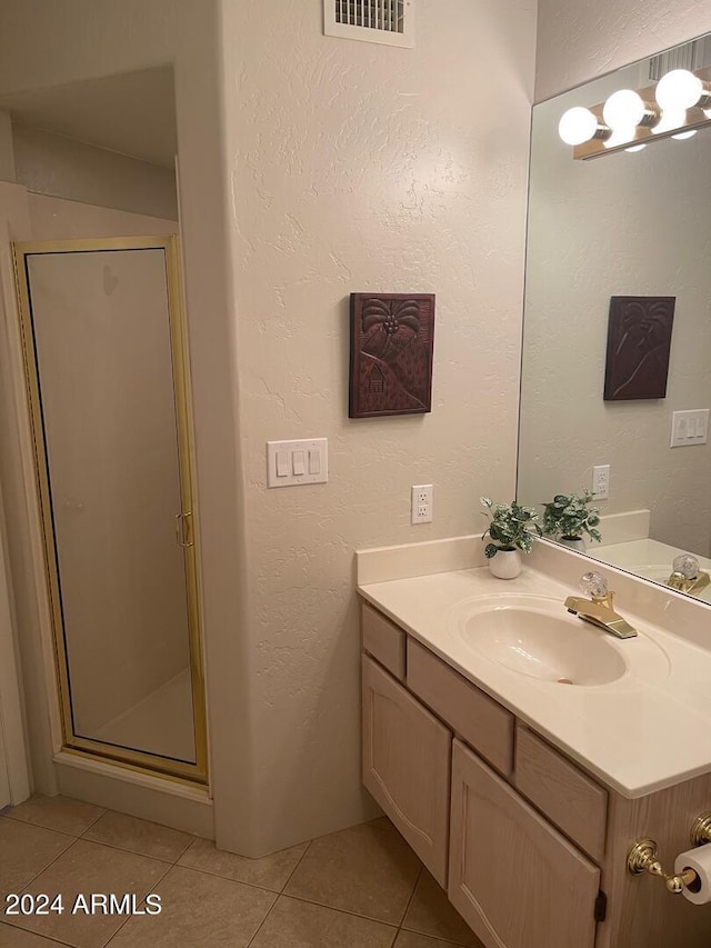 bathroom with an enclosed shower, tile floors, and vanity