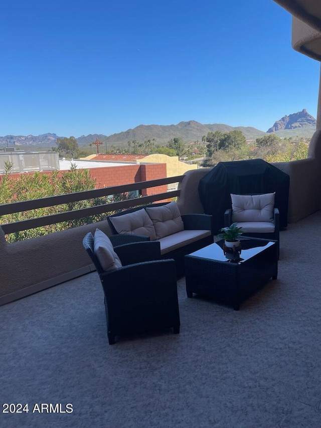 view of patio with a mountain view, a balcony, and outdoor lounge area