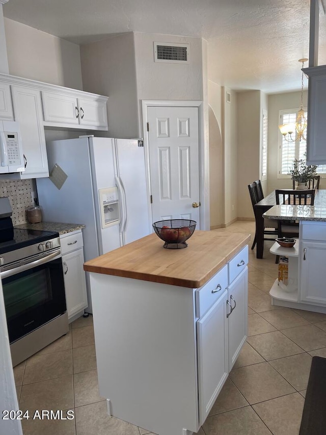 kitchen with white cabinets, a kitchen island, white appliances, and an inviting chandelier