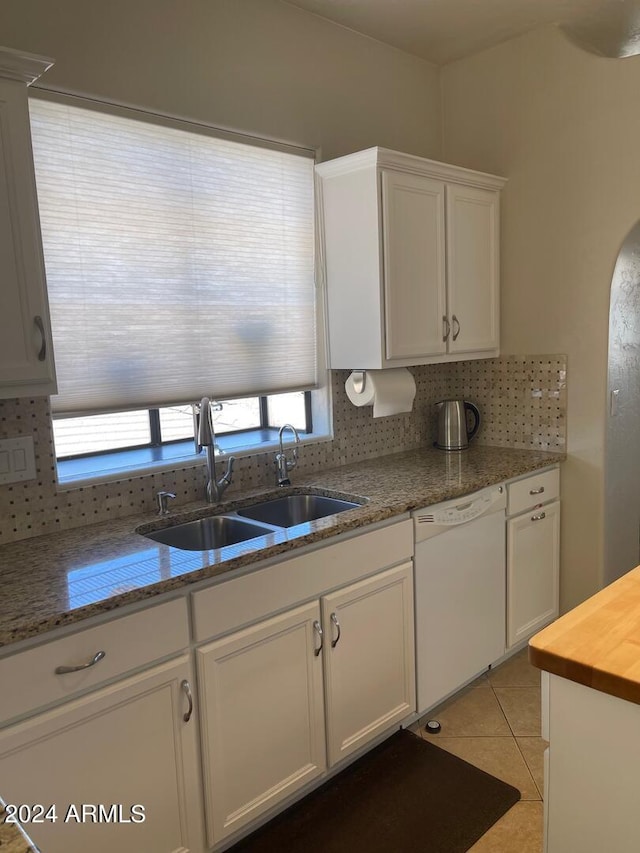 kitchen featuring backsplash, white cabinetry, dishwasher, and sink