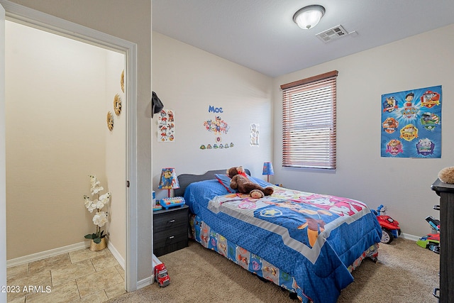 bedroom featuring light carpet