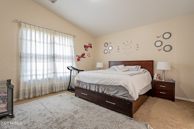 bedroom featuring light colored carpet and vaulted ceiling