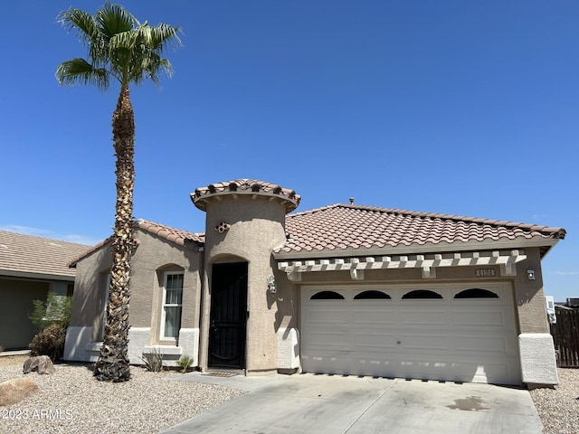 mediterranean / spanish-style house with a garage