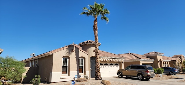 mediterranean / spanish house with a garage