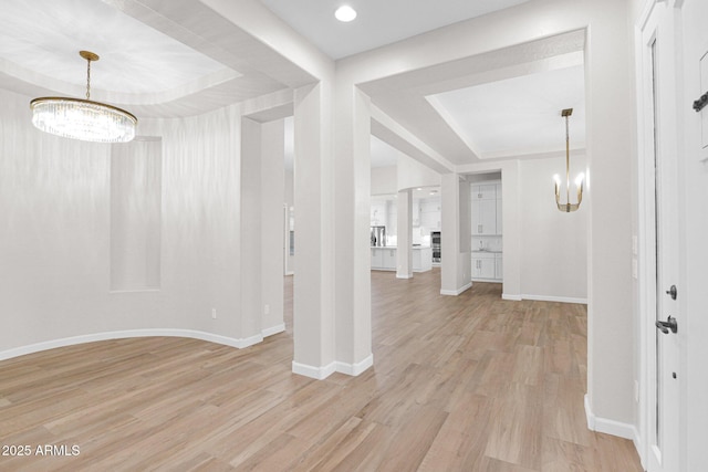 20115 E Sonoqui Blvd E, Queen Creek, AZ 85142 - hallway featuring a chandelier, a tray ceiling, and light wood-style flooring