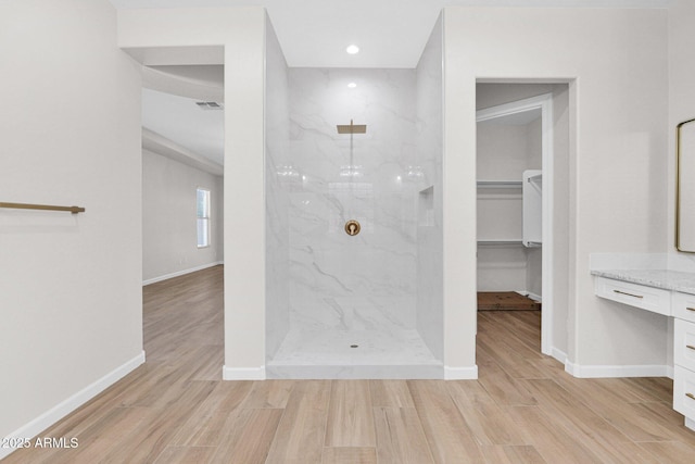 20115 E Sonoqui Blvd E, Queen Creek, AZ 85142 - bathroom featuring vanity, a marble finish shower, wood finished floors, a walk in closet, and recessed lighting