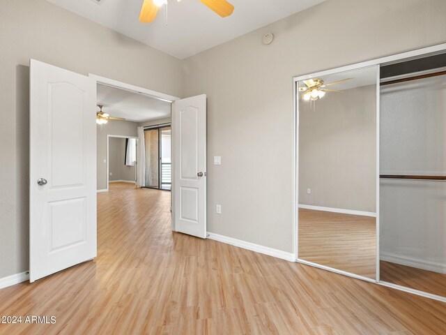 unfurnished bedroom with light hardwood / wood-style flooring, a closet, and ceiling fan