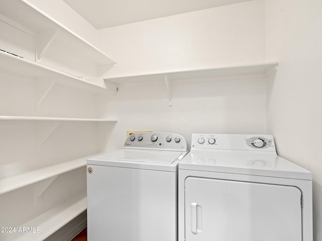 clothes washing area featuring separate washer and dryer