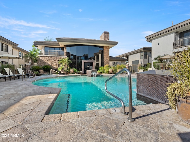 view of pool featuring pool water feature and a patio area