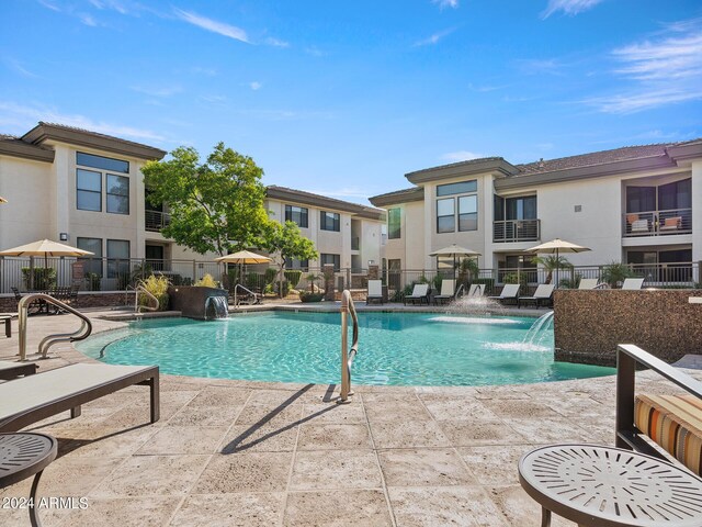 view of swimming pool with a patio and pool water feature