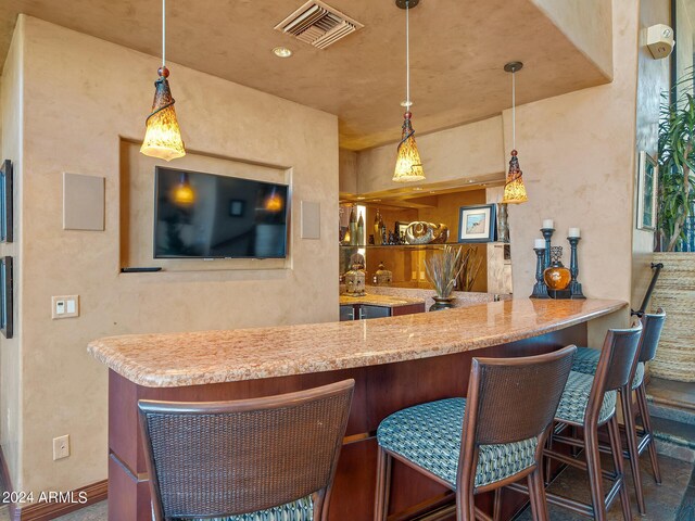 bar featuring hanging light fixtures