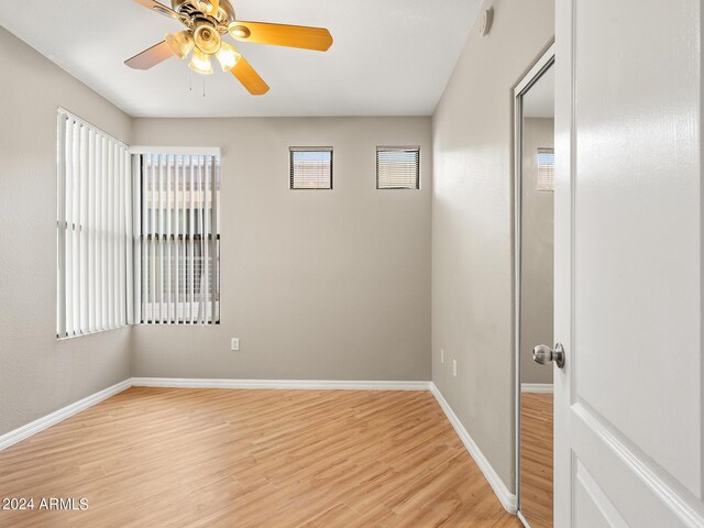 unfurnished bedroom featuring light hardwood / wood-style floors, ensuite bath, and ceiling fan